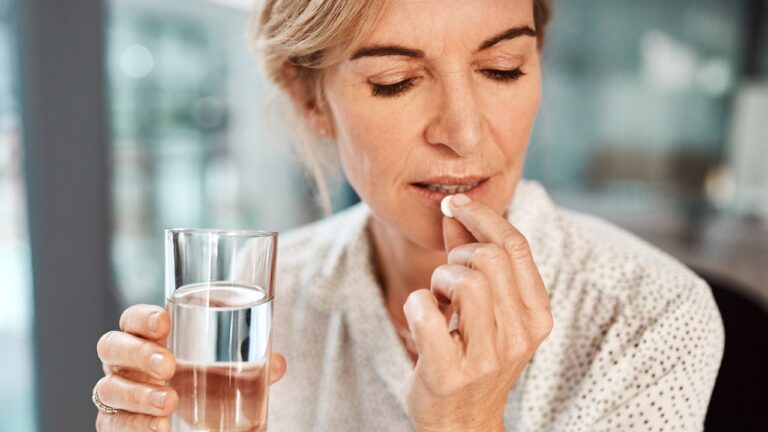 woman taking aspirin