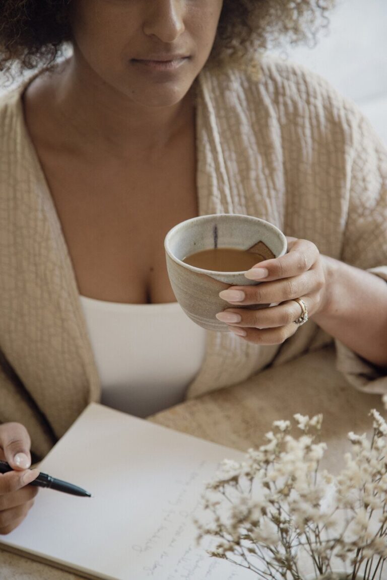 woman drinking coffee journaling 865x1298